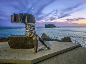 View of Sappho Sculpture at Skala Eresou with Bader Rock in the background