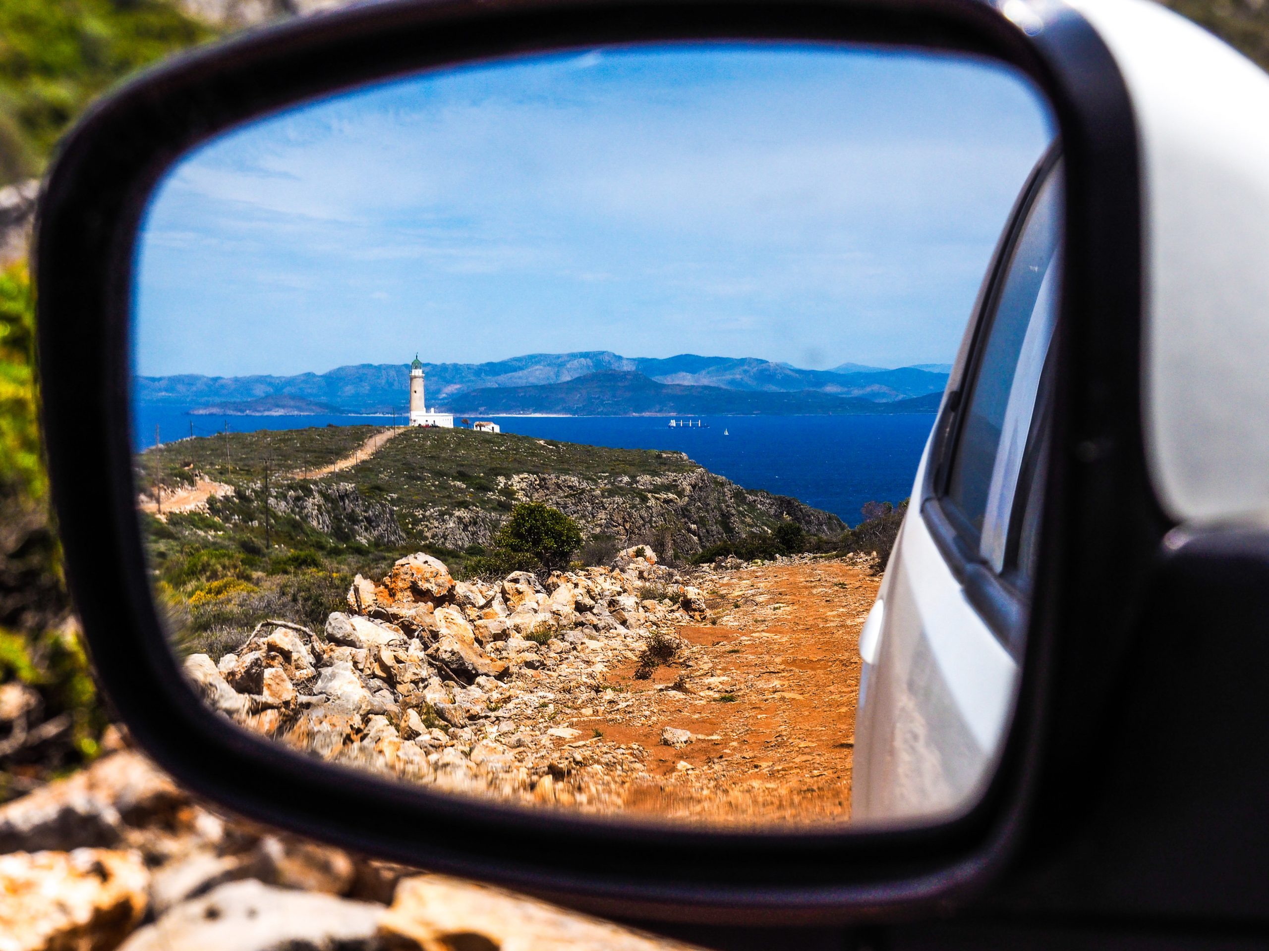 View of Kythira Lighthouse through wing mirror