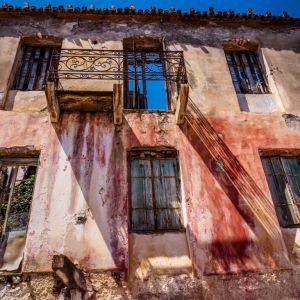 Gythio - May 2019. Up above the harbour lay crumbling mansion houses many with just their facade standing. They still maintain an air of grandeur. I love the pattern that is cast by shadow of the balcony.