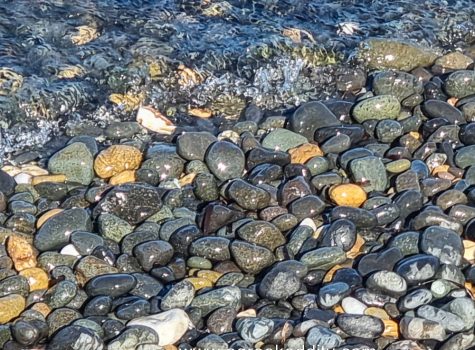 Lesvos 2022 Pebbled beach at Eftalou with coloured marble stones and view toward Turkey.