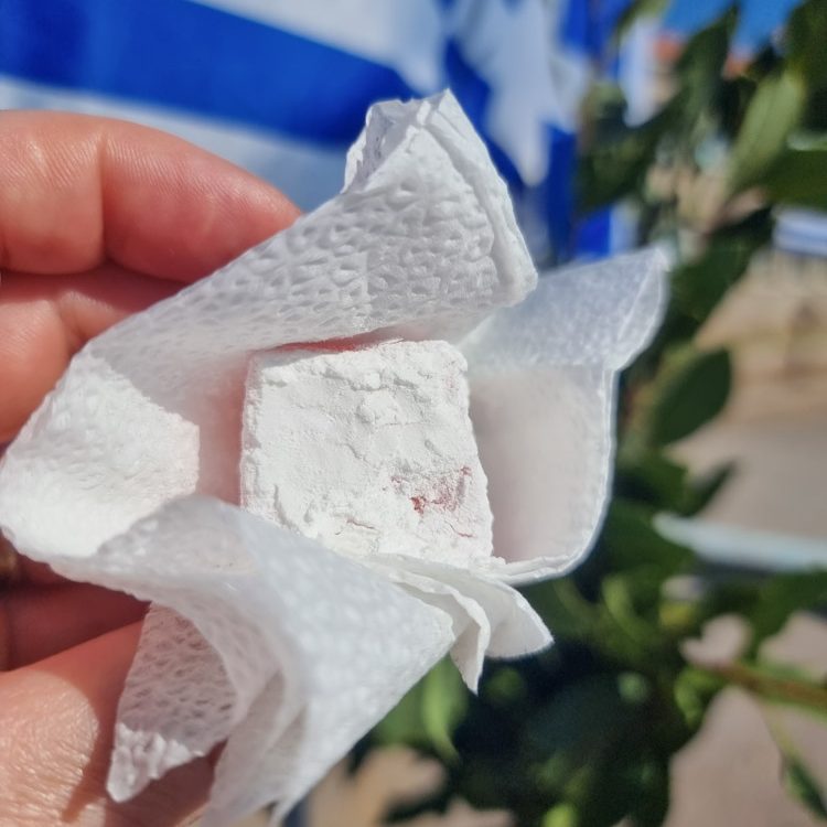 Lesvos 2022 Woman offering loukoumi during the Oxi Day celebrations in Molyvos.
