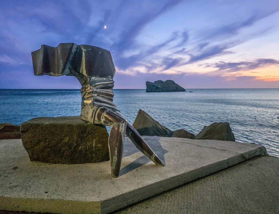 View of Sappho Sculpture at Skala Eresou with Bader Rock in the background
