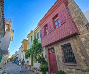 Bozcaada Merkez Street with traditional stone houses with sachnisi balconies in Bozcaada town centre.