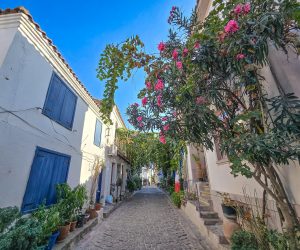 Aegean-style stone houses with blue shutters and bougainvillea in Bozcaada