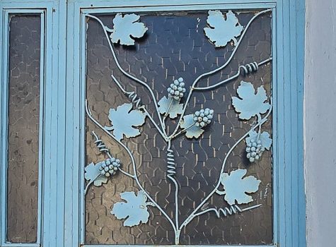 Door panel adorned with metal work representing grapes vines symbolic of Bozcaadas wine producing heritage