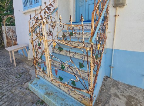 Old metal fence adorned with bunches of grapes reflecting the wine producing industry on Bozcaada